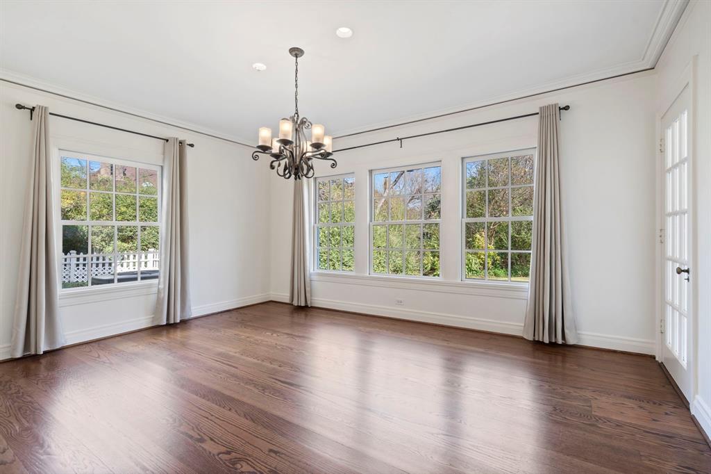 8530 Jourdan Way Dallas, TX 75225 - Photo 9 of 39 Empty room with dark wood-style floors, suspended lighting, and crown molding