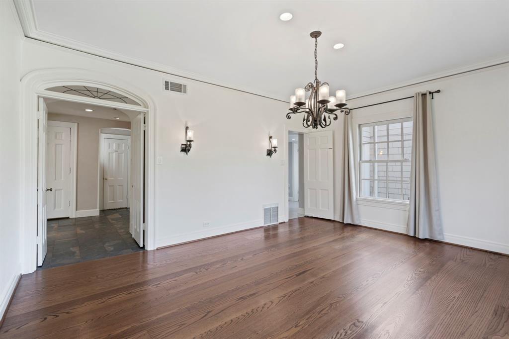8530 Jourdan Way Dallas, TX 75225 - Photo 10 of 39 Unfurnished dining area featuring a chandelier, crown molding, and dark wood-style floors