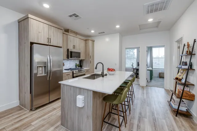 a kitchen with kitchen island cabinets and refrigerator