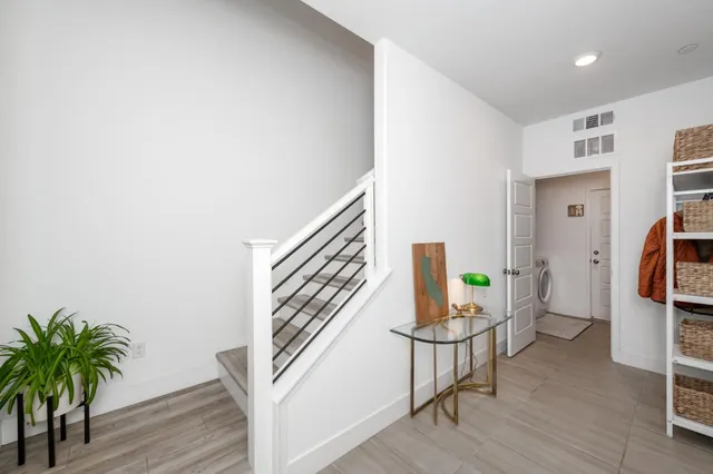 a living room with furniture a flat screen tv and a potted plant