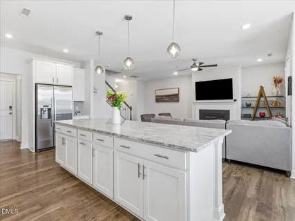 a kitchen with stainless steel appliances granite countertop a stove and a wooden floors