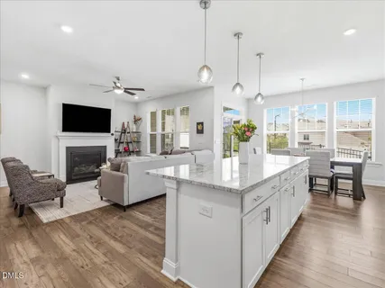 a kitchen with a refrigerator a sink and dishwasher with white cabinets
