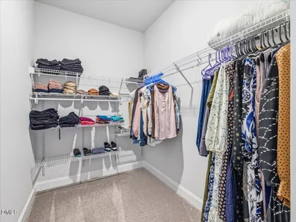 a large bed sitting in a bedroom next to a window