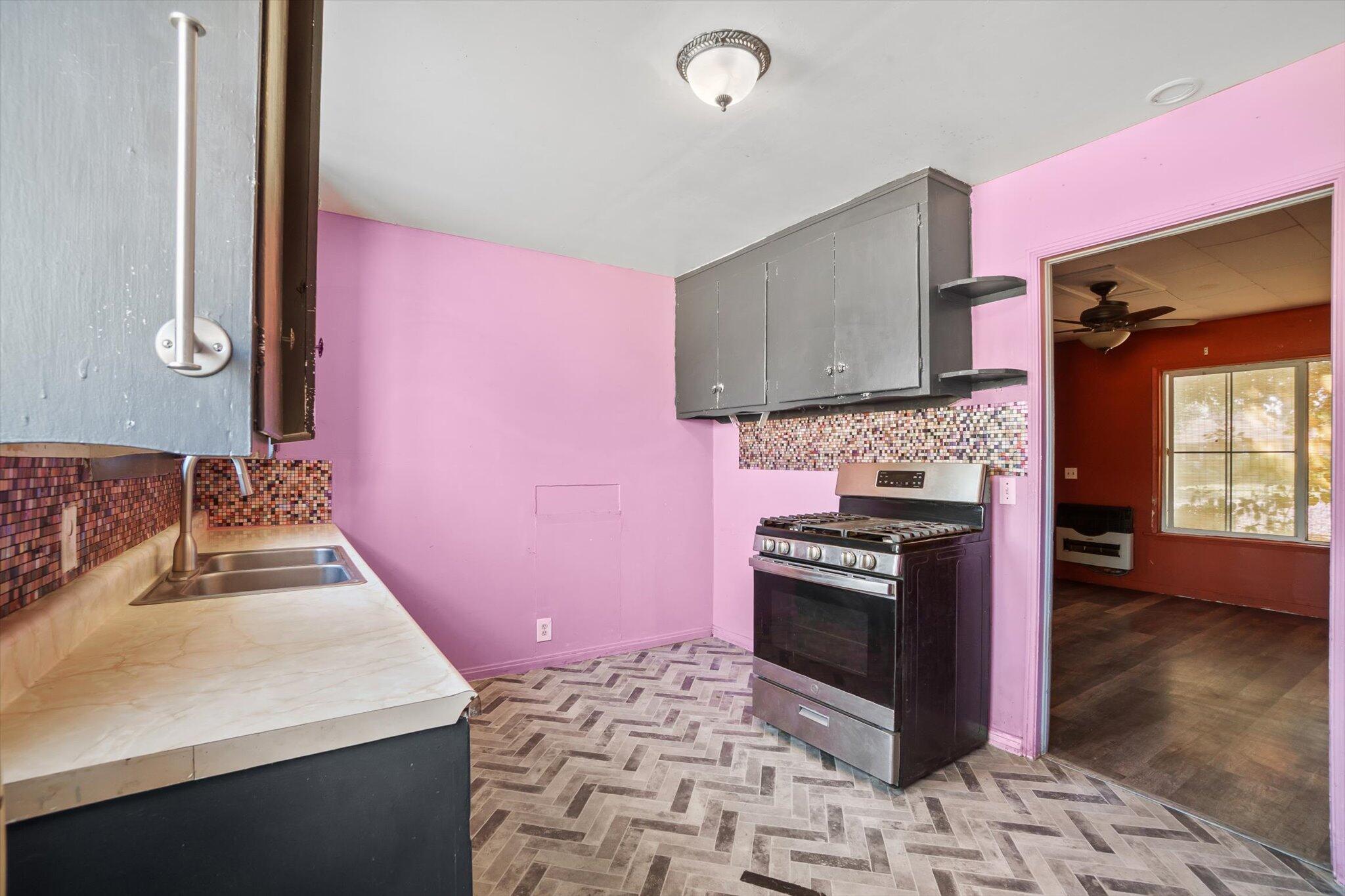 1450 Bulkeley Street Red Bluff, CA 96080 - Photo 6 of 21 a kitchen with a stove a sink and a microwave
