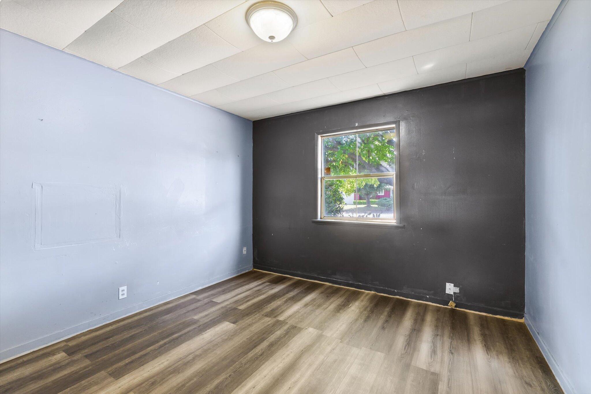 1450 Bulkeley Street Red Bluff, CA 96080 - Photo 8 of 21 an empty room with wooden floor and windows