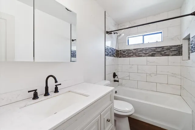 a bathroom with a sink a toilet and a bathtub