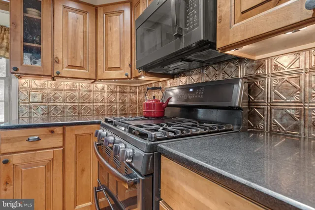 a kitchen with stainless steel appliances granite countertop a stove and a sink