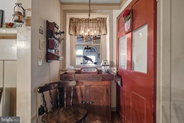 a view of hall way with furniture and chandelier