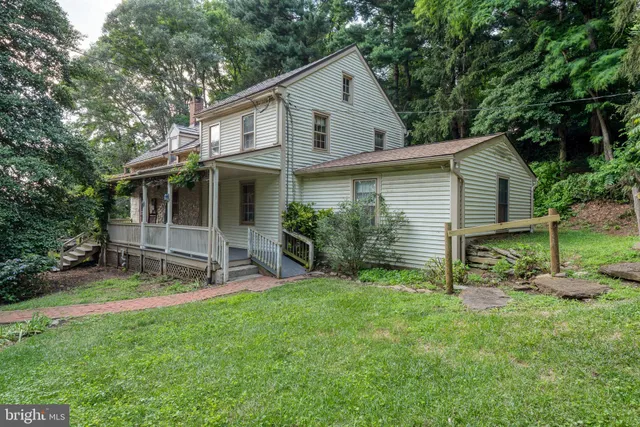 a view of a house with a yard and sitting area