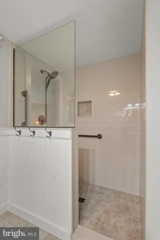 a bathroom with a granite countertop toilet sink and mirror