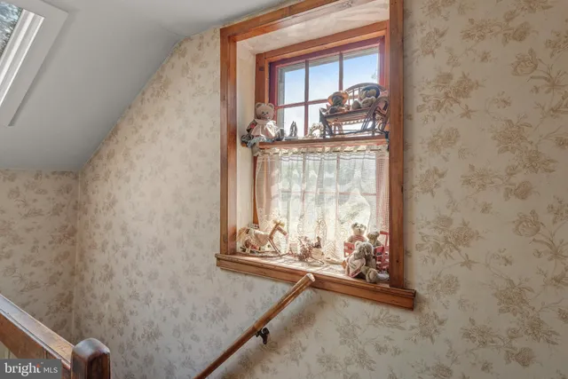 a view of a livingroom with an empty room and a window