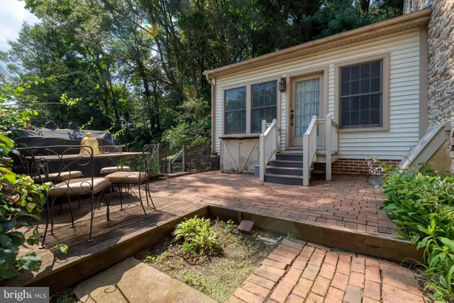 an aerial view of residential house with outdoor space and trees all around