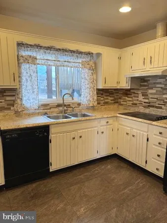 a kitchen with cabinets stainless steel appliances a sink and dishwasher
