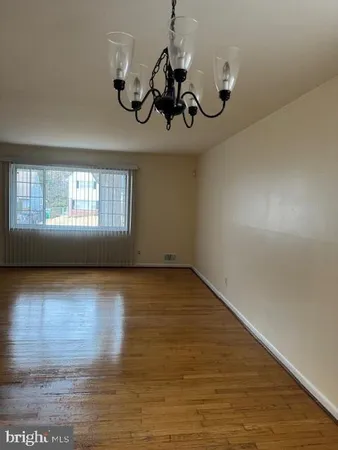 a view of a room with wooden floor and window