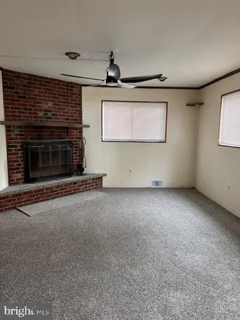 a view of an empty room with a fireplace