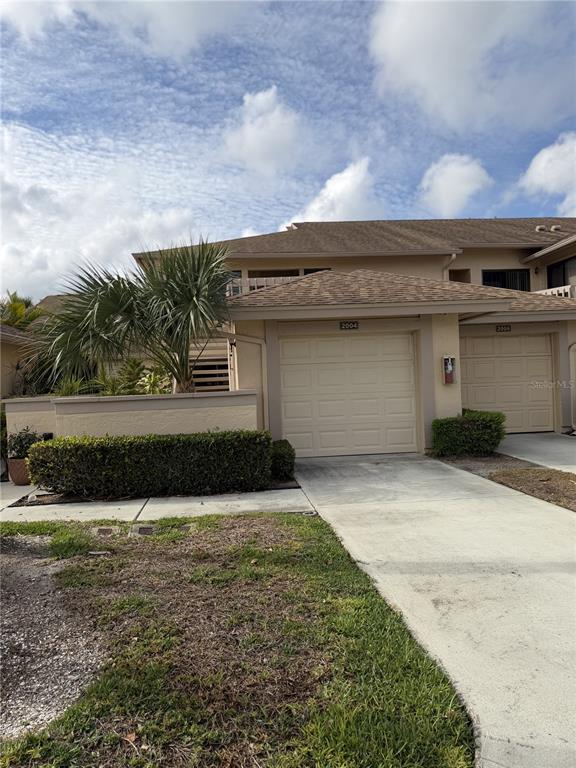 2004 Longpointe Circle Venice, FL 34293 - Photo 1 of 54 a front view of a house with a yard