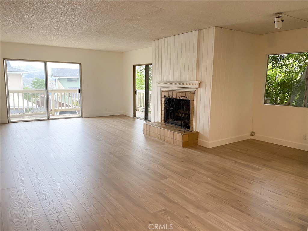 34072 Mazo Drive Dana Point, CA 92629 - Photo 11 of 73 Upper unit's living area, also showing fireplace and patio doors to wrap-around rear deck