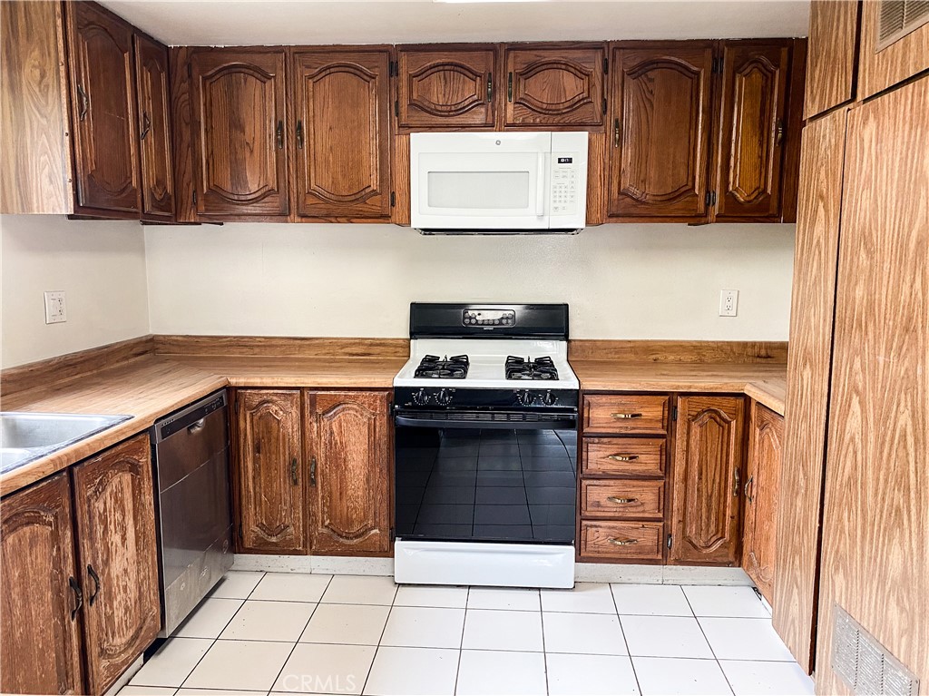 34072 Mazo Drive Dana Point, CA 92629 - Photo 18 of 73 a kitchen with stainless steel appliances granite countertop a stove and a microwave