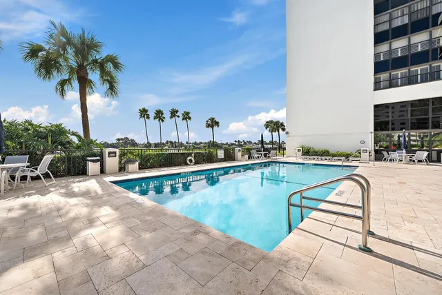 a view of swimming pool with outdoor seating and potted plants