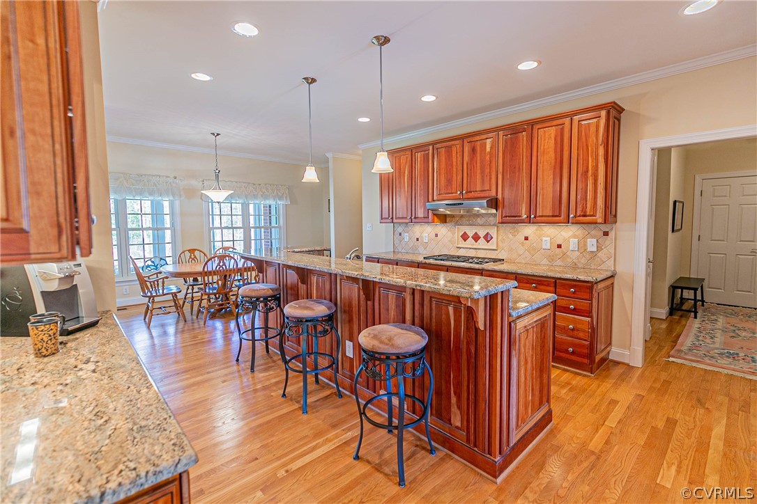 10180 Scots Landing Road Mechanicsville, VA 23116 - Photo 21 of 50 a open kitchen with stainless steel appliances granite countertop a stove a refrigerator a kitchen island a dining table and chairs with wooden floor
