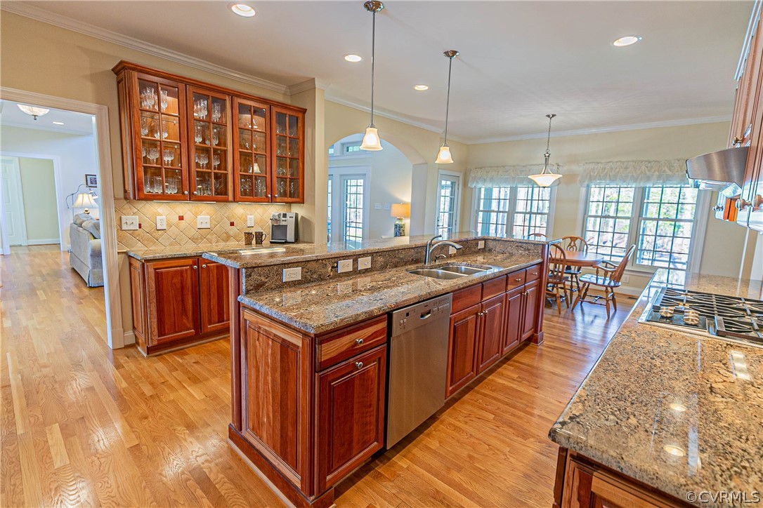 10180 Scots Landing Road Mechanicsville, VA 23116 - Photo 25 of 50 a spacious kitchen with stainless steel appliances granite countertop a stove a sink dishwasher and a dining table with wooden floor