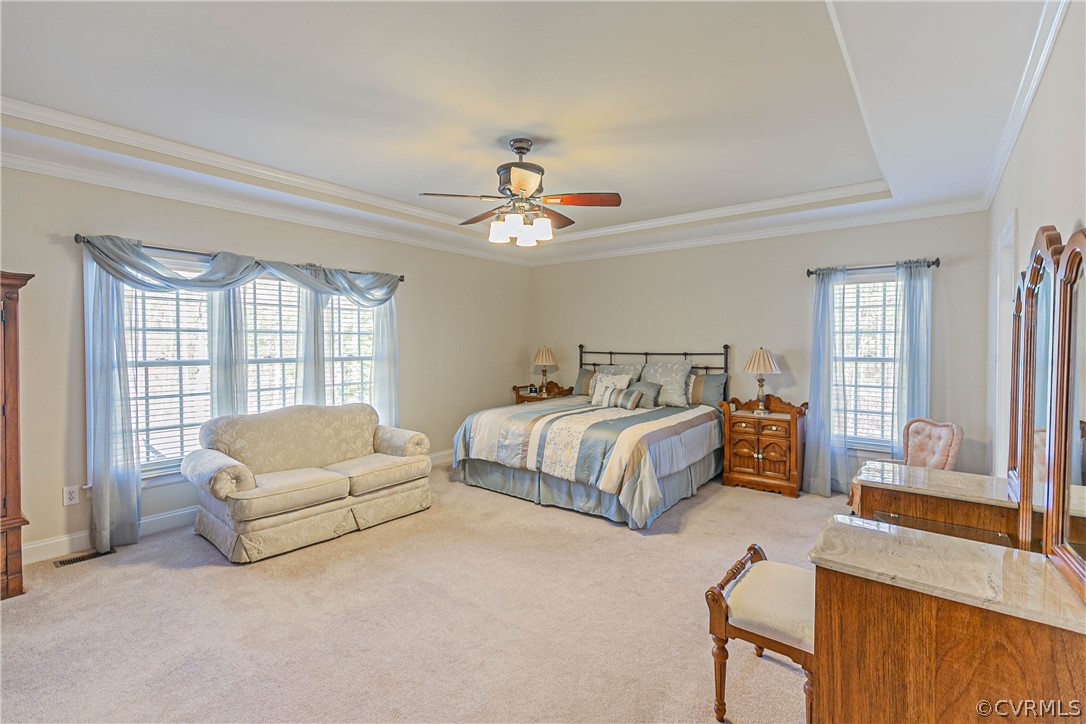 10180 Scots Landing Road Mechanicsville, VA 23116 - Photo 27 of 50 a spacious bedroom with a bed couch chandelier windows and a chandelier
