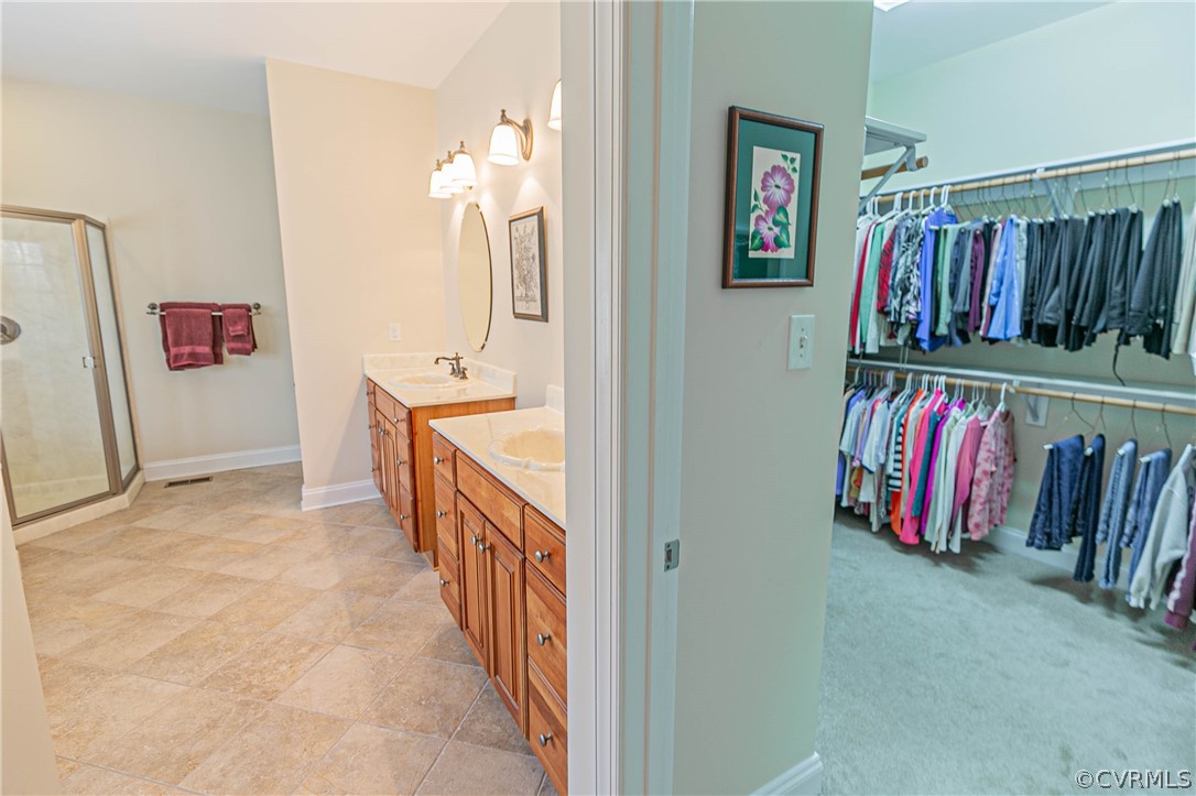 10180 Scots Landing Road Mechanicsville, VA 23116 - Photo 30 of 50 a view of walk in closet with clothes and shoes