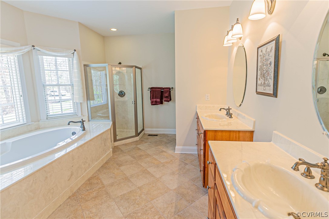 10180 Scots Landing Road Mechanicsville, VA 23116 - Photo 31 of 50 a bathroom with a tub sink and mirror
