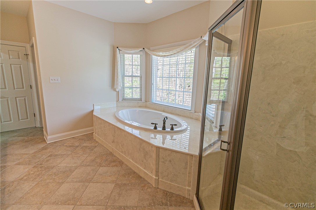 10180 Scots Landing Road Mechanicsville, VA 23116 - Photo 32 of 50 a bath tub sitting in a bathroom next to a window