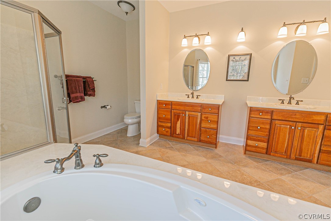 10180 Scots Landing Road Mechanicsville, VA 23116 - Photo 33 of 50 a spacious bathroom with a double vanity sink mirror and bathtub