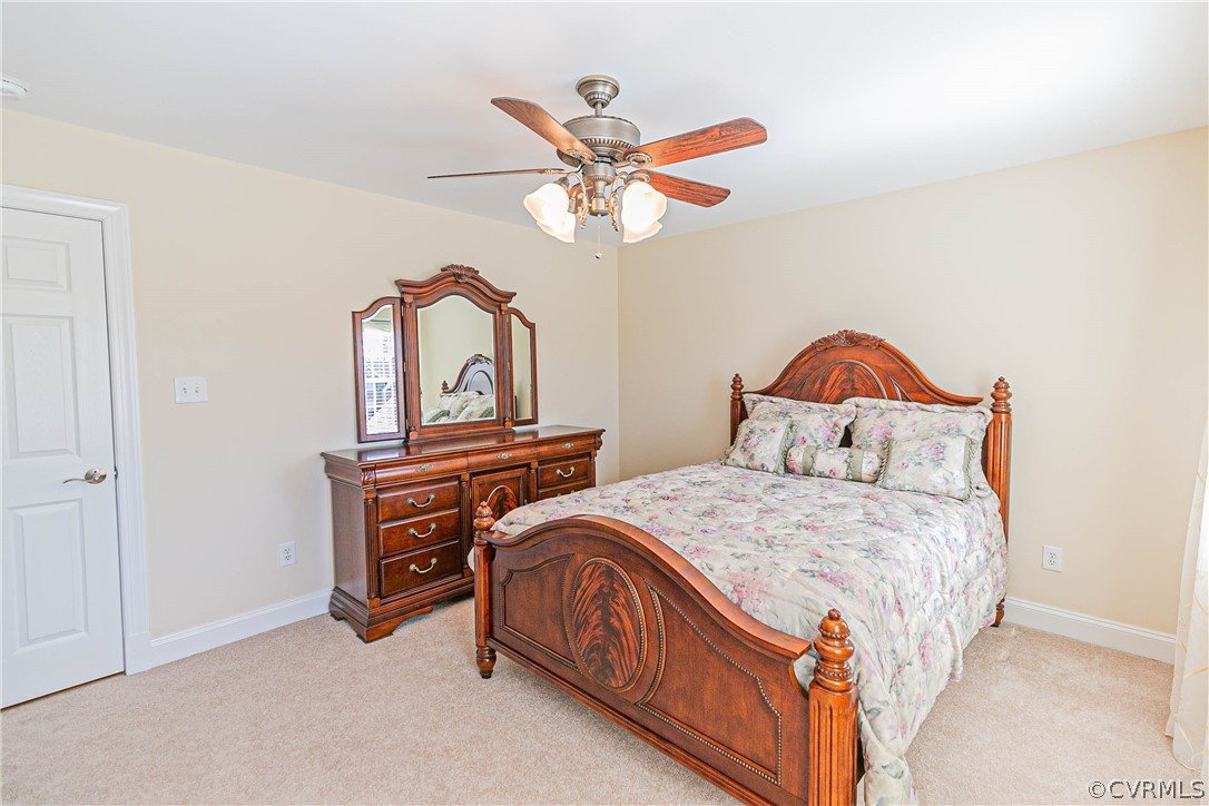 10180 Scots Landing Road Mechanicsville, VA 23116 - Photo 41 of 50 a bedroom with a bed and a chandelier