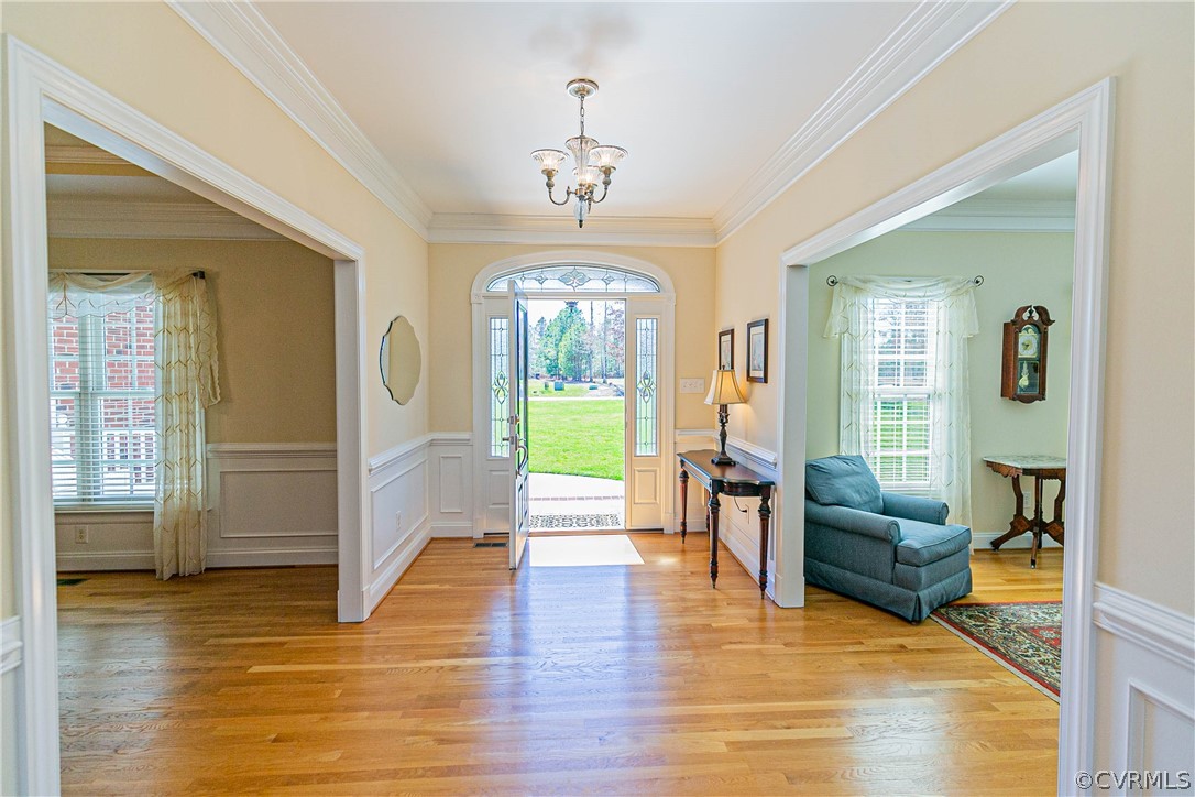 10180 Scots Landing Road Mechanicsville, VA 23116 - Photo 6 of 50 a living room with furniture and a chandelier