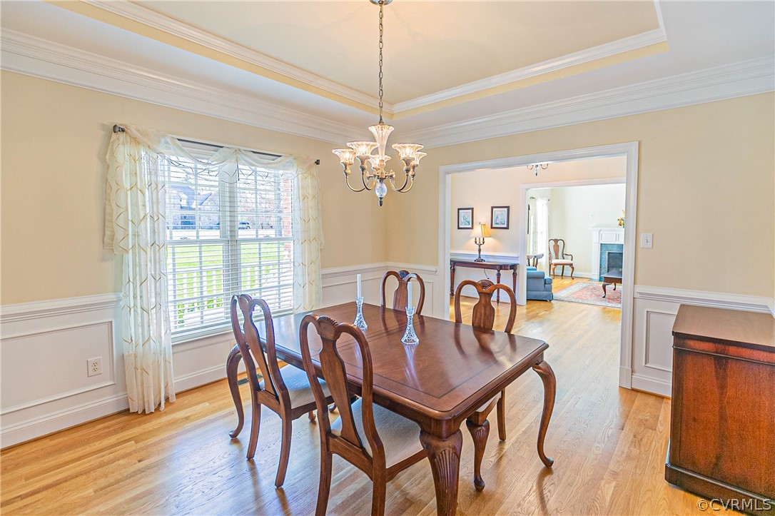 10180 Scots Landing Road Mechanicsville, VA 23116 - Photo 9 of 50 a dining room with furniture a chandelier and wooden floor