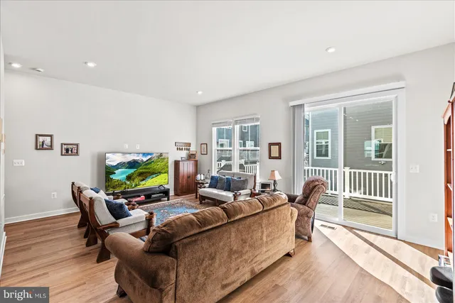 a bedroom with a bed window and a night stand