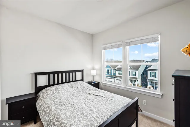 a bed sitting in a bedroom next to a window