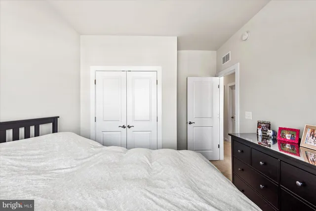 a bathroom with a granite countertop sink toilet and shower a mirror