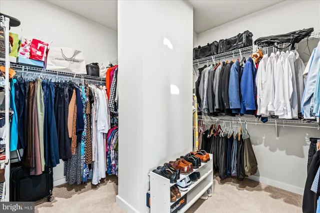a spacious bathroom with a double vanity sink a mirror and shower