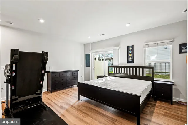 a bathroom with a granite countertop sink toilet mirror and bathtub
