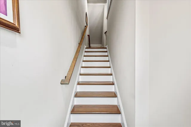 a kitchen with stainless steel appliances a refrigerator sink and wooden floor