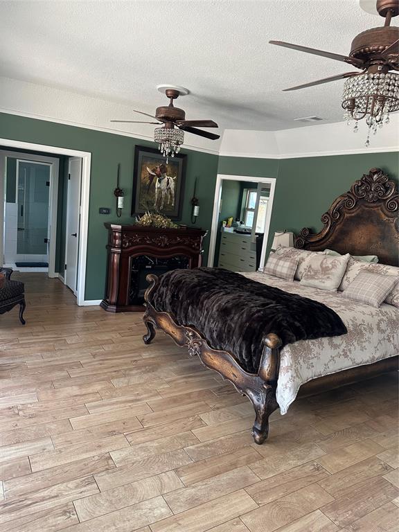 505 High Road Coleman, TX 76834 - Photo 17 of 38 a bedroom with a bed a chandelier and dresser