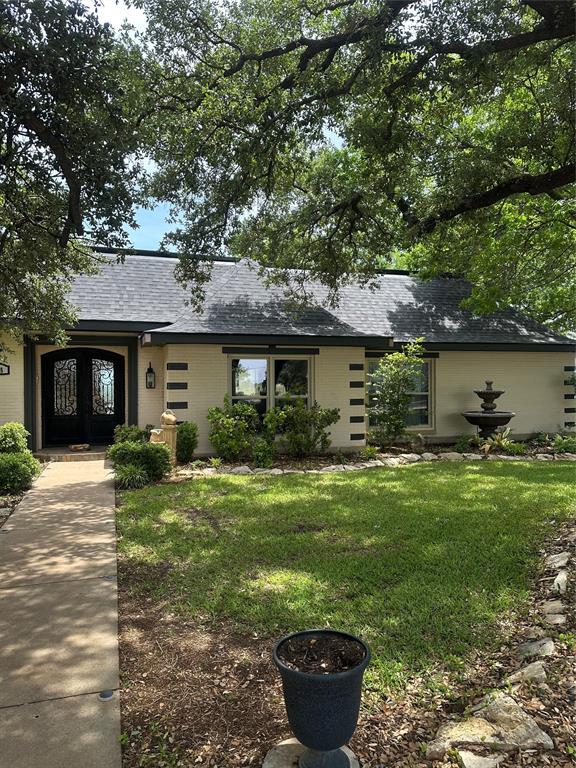 505 High Road Coleman, TX 76834 - Photo 4 of 38 a front view of a house with garden and porch