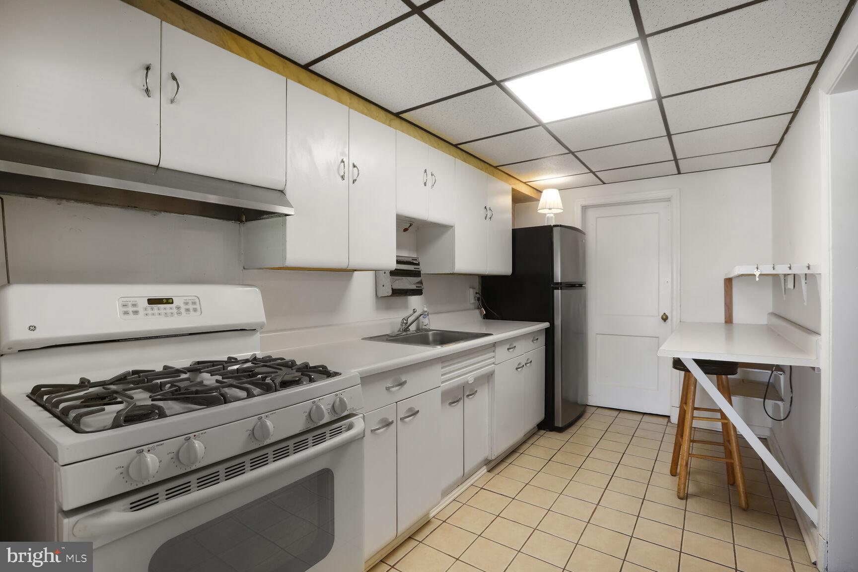 1892 Church Road Baltimore, MD 21222 - Photo 5 of 20 a kitchen with a stove a sink and a refrigerator