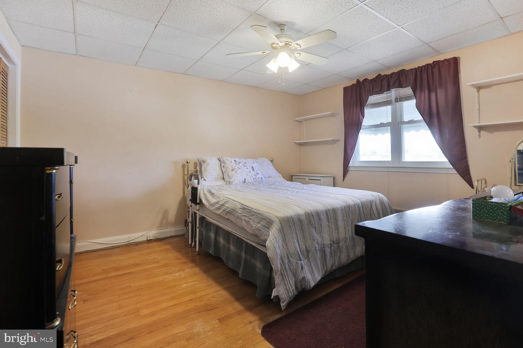 1892 Church Road Baltimore, MD 21222 - Photo 8 of 20 a bedroom with a bed table and a window