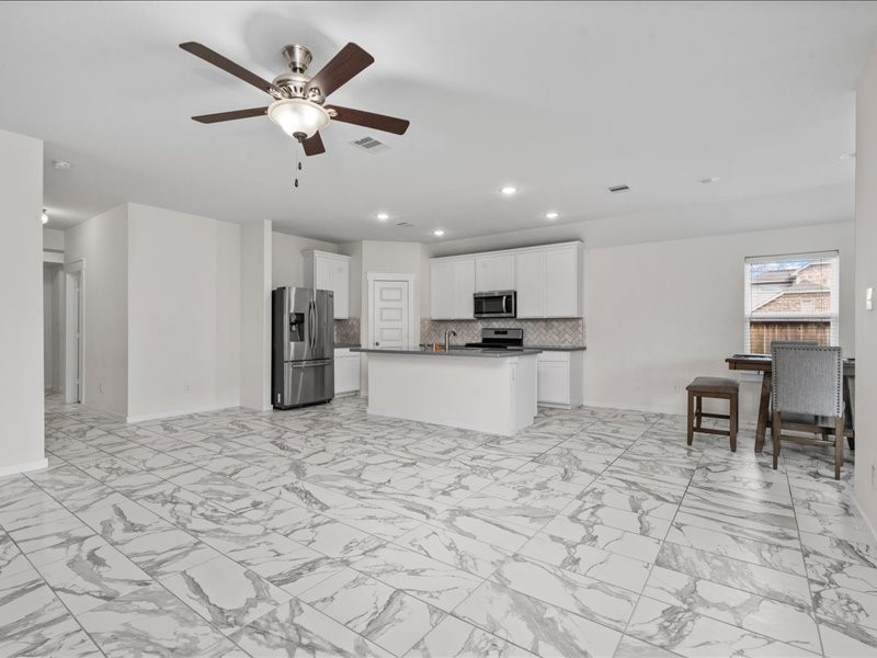 9203 Waldrick Trace Drive Rosharon, TX 77583 - Photo 12 of 35 a view of kitchen with stainless steel appliances kitchen island granite countertop cabinets a sink a stove a dining table and chairs