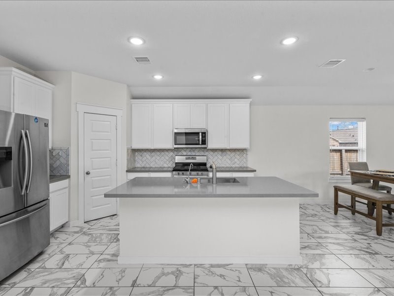 9203 Waldrick Trace Drive Rosharon, TX 77583 - Photo 13 of 35 a kitchen with stainless steel appliances granite countertop a sink a stove and a refrigerator