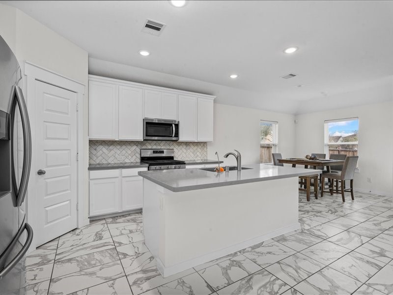 9203 Waldrick Trace Drive Rosharon, TX 77583 - Photo 14 of 35 a kitchen with appliances cabinets and a sink