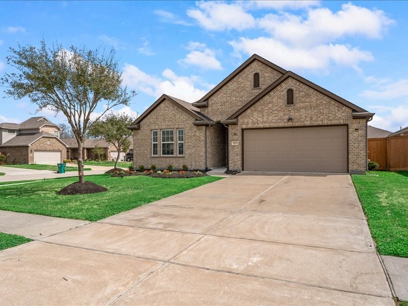 9203 Waldrick Trace Drive Rosharon, TX 77583 - Photo 2 of 35 a front view of a house with a yard and trees