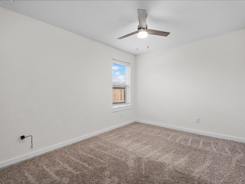 9203 Waldrick Trace Drive Rosharon, TX 77583 - Photo 8 of 35 an empty room with a chandelier fan and windows