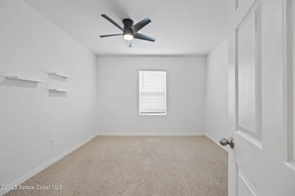 an empty room with ceiling fan
