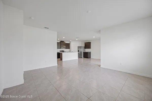 a view of a kitchen with a sink and a refrigerator